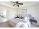 Bright primary bedroom featuring tray ceiling, neutral colors, and an en suite bathroom at 6420 Tunston Ln, Charlotte, NC 28269