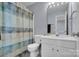 This bathroom features a vanity, a toilet, a shower with a curtain and blue walls at 6738 Rothchild Dr, Charlotte, NC 28270