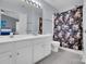 Bathroom featuring a double vanity, a large mirror, and a shower with a floral curtain at 6738 Rothchild Dr, Charlotte, NC 28270