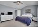 This spacious primary bedroom includes carpet floors, blue walls, natural light and a ceiling fan at 6738 Rothchild Dr, Charlotte, NC 28270