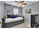 This bedroom is highlighted by blue walls, carpet flooring, ceiling fan, and a pullout sofa at 6738 Rothchild Dr, Charlotte, NC 28270