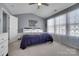 This primary bedroom features carpet floors, blue walls, natural light and a ceiling fan at 6738 Rothchild Dr, Charlotte, NC 28270