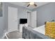 This bedroom is highlighted by blue walls, carpet flooring, ceiling fan, and a pullout sofa at 6738 Rothchild Dr, Charlotte, NC 28270