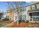 Attractive townhouses featuring colorful exterior finishes, well-manicured landscaping, and inviting walkways at 6738 Rothchild Dr, Charlotte, NC 28270