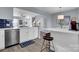 Kitchen island featuring white countertop, wooden bar stools and stainless steel dishwasher at 6738 Rothchild Dr, Charlotte, NC 28270