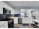 Bright kitchen area with white cabinetry, stainless steel appliances and open floorplan view at 6738 Rothchild Dr, Charlotte, NC 28270