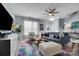 Bright living room featuring a comfortable blue sofa, colorful rug, and plenty of natural light at 6738 Rothchild Dr, Charlotte, NC 28270