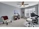 This home office features a window, carpet flooring, a ceiling fan, and gray walls at 6738 Rothchild Dr, Charlotte, NC 28270