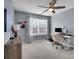 This home office features a window, carpet flooring, a ceiling fan, and gray walls at 6738 Rothchild Dr, Charlotte, NC 28270