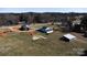 Scenic aerial view of the property featuring several outbuildings, mature trees, and plenty of open space at 850 Dunns Mountain Church Rd # 1, Salisbury, NC 28146