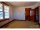 Bedroom with older carpet and walls, and one window with side closets at 850 Dunns Mountain Church Rd # 1, Salisbury, NC 28146