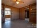 Den with wood paneling, a ceiling fan, shelving and access to other rooms at 850 Dunns Mountain Church Rd # 1, Salisbury, NC 28146