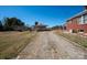 Gravel driveway leading to home with outbuilding and grassy side yard at 850 Dunns Mountain Church Rd # 1, Salisbury, NC 28146