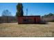 View of red brick outbuilding with window openings and grassy field at 850 Dunns Mountain Church Rd # 1, Salisbury, NC 28146