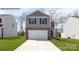 Two-story home featuring a two-car garage and a stone and gray siding exterior at 878 Two Brothers Ln, York, SC 29745