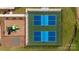 Aerial view of dual well-maintained pickleball courts and a colorful playground surrounded by lush landscaping at 878 Two Brothers Ln, York, SC 29745