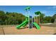 A vibrant playground with a green slide and climbing structures set on a safe, wood-chip surface for active play at 878 Two Brothers Ln, York, SC 29745