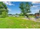 Expansive backyard with lush green grass, mature trees, and an outdoor dining area at 905 Blalock Dr, Kings Mountain, NC 28086