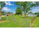Spacious backyard with mature trees, a metal fence, and a detached garage at 905 Blalock Dr, Kings Mountain, NC 28086