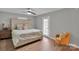 Relax in the spacious bedroom, featuring an accent chair, neutral paint, wood-look flooring, and natural light at 905 Blalock Dr, Kings Mountain, NC 28086