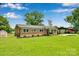 Brick home with green lawn, mature trees, and a welcoming front porch at 905 Blalock Dr, Kings Mountain, NC 28086