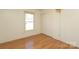 Bedroom with hardwood floors, a window, and a closet with sliding doors at 9100 Clancy Pl, Charlotte, NC 28227