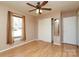 This bedroom features a ceiling fan, hardwood floors, and a window for natural light at 9100 Clancy Pl, Charlotte, NC 28227