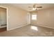 Cozy bedroom features neutral walls, plush carpet, and a ceiling fan for added comfort at 9100 Clancy Pl, Charlotte, NC 28227