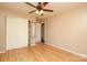 A bedroom with hardwood floors, a ceiling fan, and a closet with sliding doors at 9100 Clancy Pl, Charlotte, NC 28227