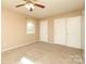 Spacious bedroom with plush carpet, neutral walls, closet, and natural light at 9100 Clancy Pl, Charlotte, NC 28227