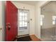 Entryway showing a red front door with sidelight, leading into a room with neutral walls and ample natural light at 9100 Clancy Pl, Charlotte, NC 28227