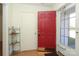 Bright entryway featuring a red front door, sidelight window, and neutral decor creating a welcoming first impression at 9100 Clancy Pl, Charlotte, NC 28227