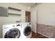 Well-equipped laundry room with modern washer, dryer, and shelving for ample storage at 9100 Clancy Pl, Charlotte, NC 28227