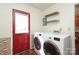 Functional laundry room with washer, dryer, shelving, and convenient access to the outside at 9100 Clancy Pl, Charlotte, NC 28227
