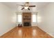 Hardwood flooring and brick fireplace in living room at 9100 Clancy Pl, Charlotte, NC 28227