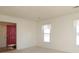 Bright, carpeted living room featuring neutral walls, white trim, and natural light from windows with classic curtains at 9100 Clancy Pl, Charlotte, NC 28227
