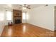 Spacious living room features a cozy brick fireplace and hardwood flooring at 9100 Clancy Pl, Charlotte, NC 28227
