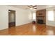 The hardwood floor and brick fireplace adds warmth to the living room at 9100 Clancy Pl, Charlotte, NC 28227