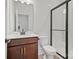Modern bathroom with a brown vanity, quartz countertop, and a black-framed glass enclosed shower at 9512 Coast Laurel Nw Ave # 42, Concord, NC 28027