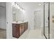 Stylish bathroom featuring double sinks, a large mirror, and a modern glass shower at 9512 Coast Laurel Nw Ave # 42, Concord, NC 28027