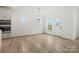Bright dining area with light-colored wood floors and windows overlooking the neighborhood at 9512 Coast Laurel Nw Ave # 42, Concord, NC 28027
