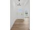 Bright entryway featuring hardwood floors, a modern light fixture, and a glimpse of the outdoors at 9512 Coast Laurel Nw Ave # 42, Concord, NC 28027