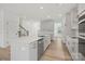 Bright kitchen featuring a large island, stainless steel dishwasher, and views to the staircase at 9512 Coast Laurel Nw Ave # 42, Concord, NC 28027