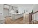A spacious kitchen featuring a large island, stainless steel appliances, and white cabinetry at 9512 Coast Laurel Nw Ave # 42, Concord, NC 28027