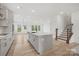 Open floor plan with modern kitchen, spacious living area and wood floors at 9512 Coast Laurel Nw Ave # 42, Concord, NC 28027