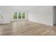 Spacious living room with hardwood floors, white walls, and large windows offering ample light at 9512 Coast Laurel Nw Ave # 42, Concord, NC 28027