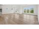 Light-filled living space with hardwood floors, large windows, and a view of the neighborhood at 9512 Coast Laurel Nw Ave # 42, Concord, NC 28027