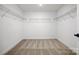 Empty walk-in closet with carpeted floor and wire shelving at 9512 Coast Laurel Nw Ave # 42, Concord, NC 28027