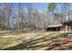 Expansive backyard featuring mature trees and large grassy area at 10007 Mountain Apple Dr, Mint Hill, NC 28227