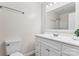 Bright bathroom with a white vanity, toilet, and shower with glass doors at 10007 Mountain Apple Dr, Mint Hill, NC 28227